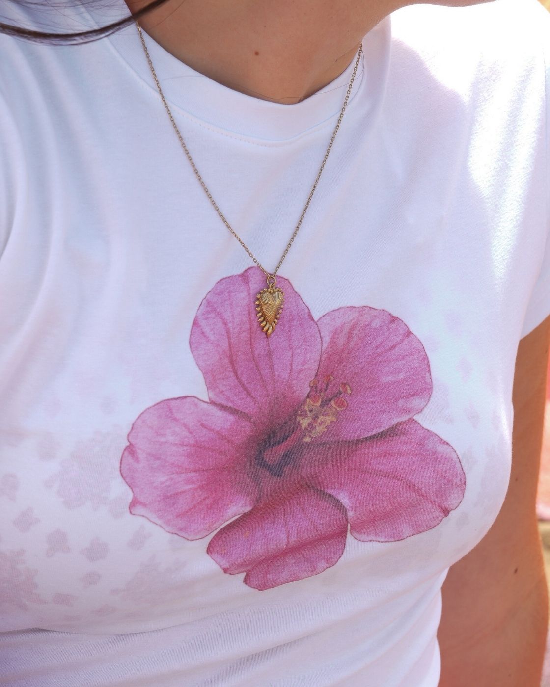 Close-up of Blaire Hibiscus Baby Tee fabric, soft cotton texture with pink floral print detail.