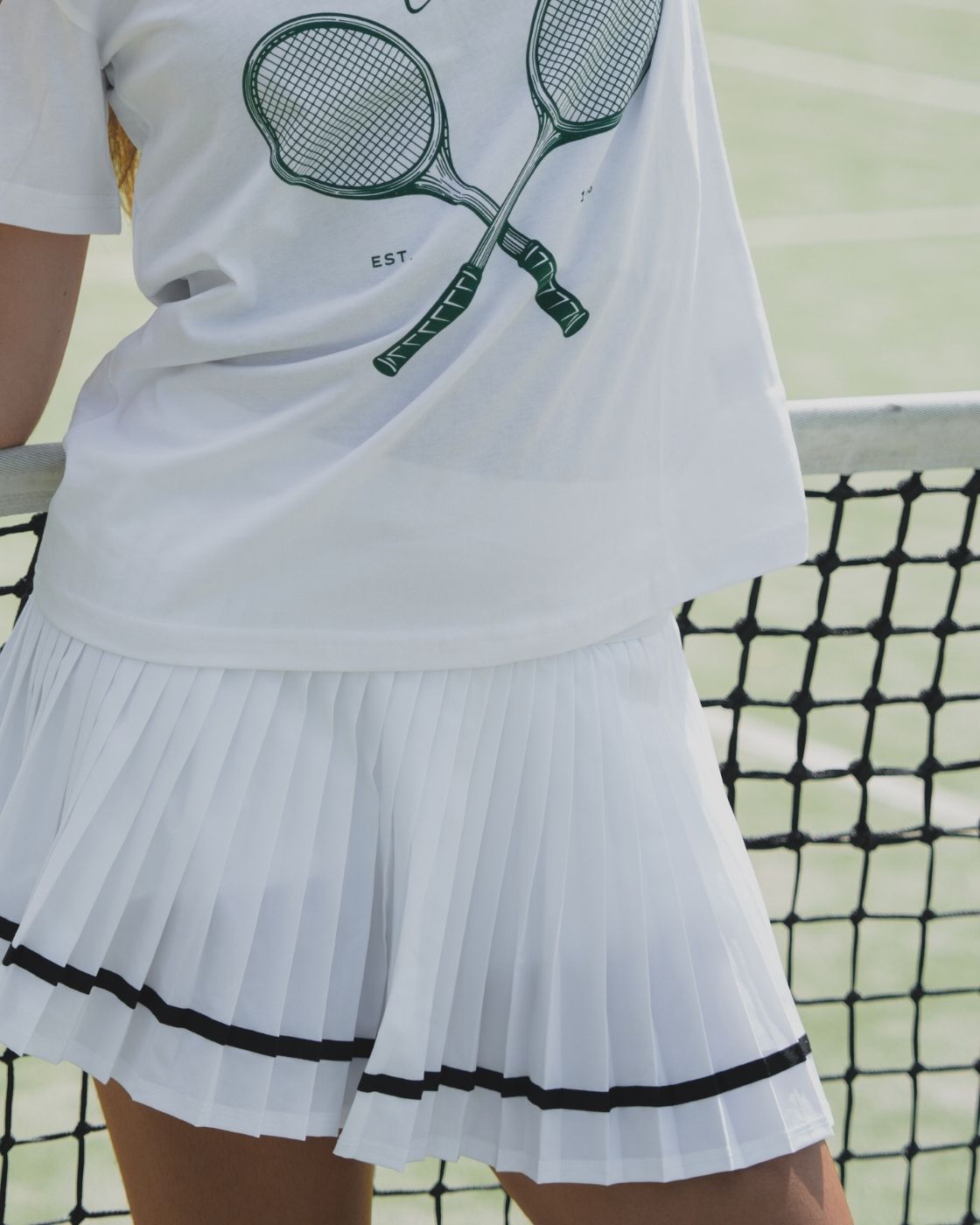 Detailed close-up of the hem on the Blaire Tennis Club Tee showing stitching quality and construction.