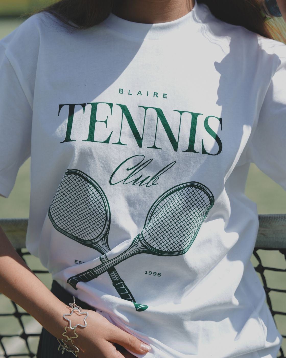 Detailed close-up of the tennis club graphic on the Blaire Tennis Club Tee.